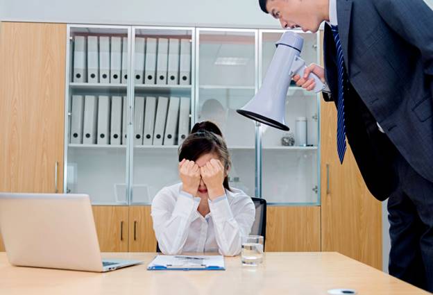 Man shouting at female coworker with bullhorn - Employment Law